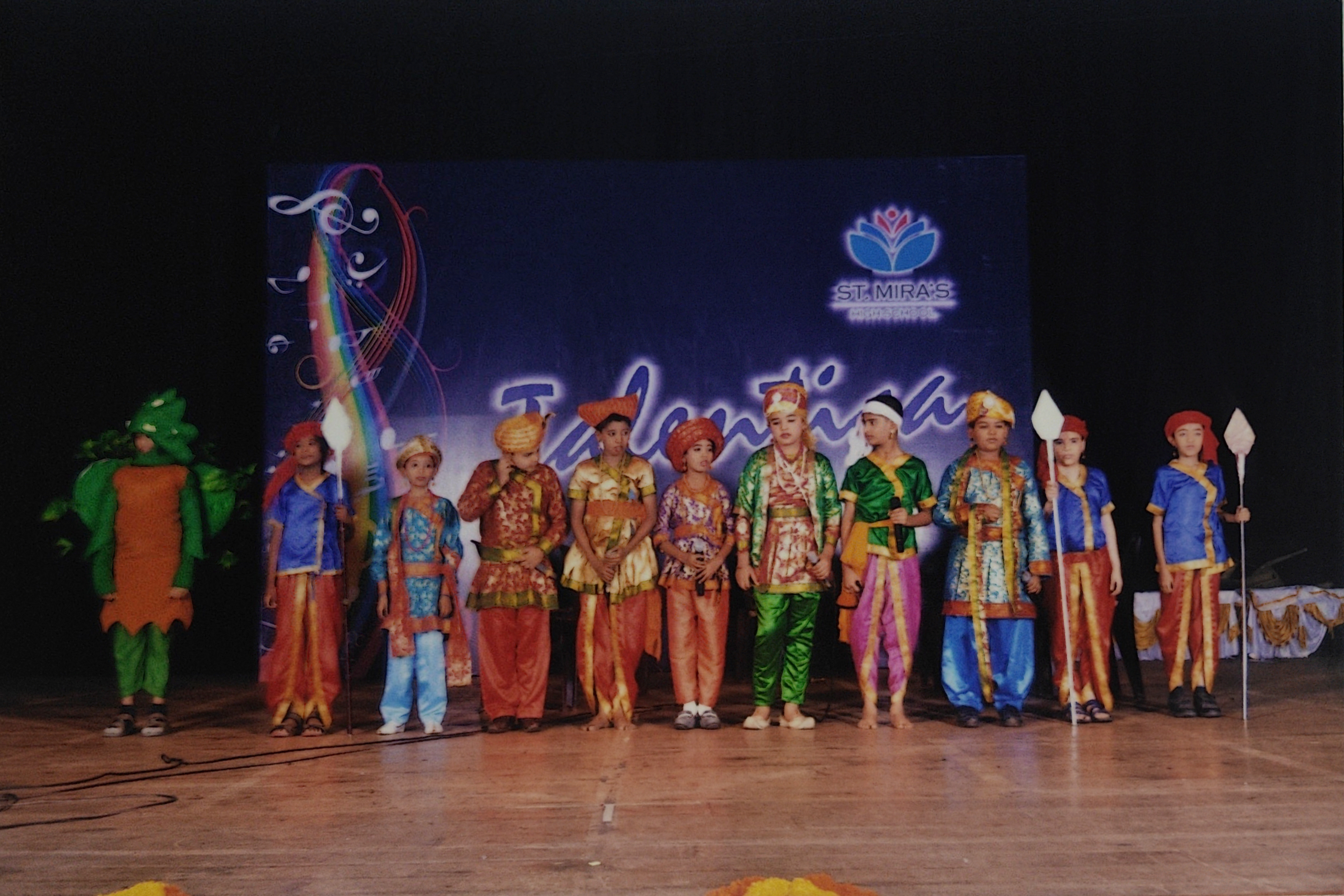 Full cast lineup on stage with Birbal, courtiers, and guards at St. Mira's High School fest.