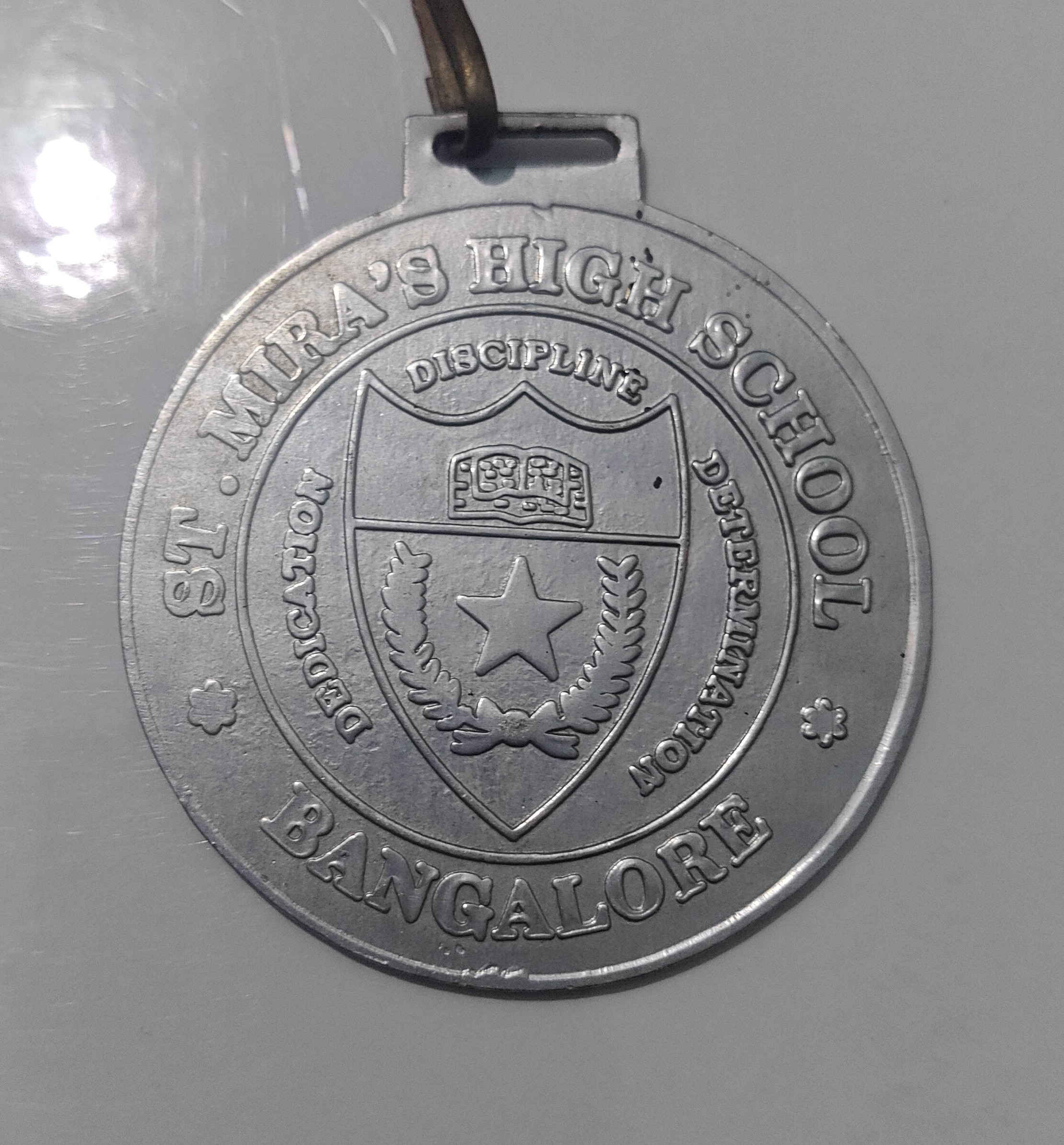 Official silver medal awarded by St. Mira's High School Bangalore.
