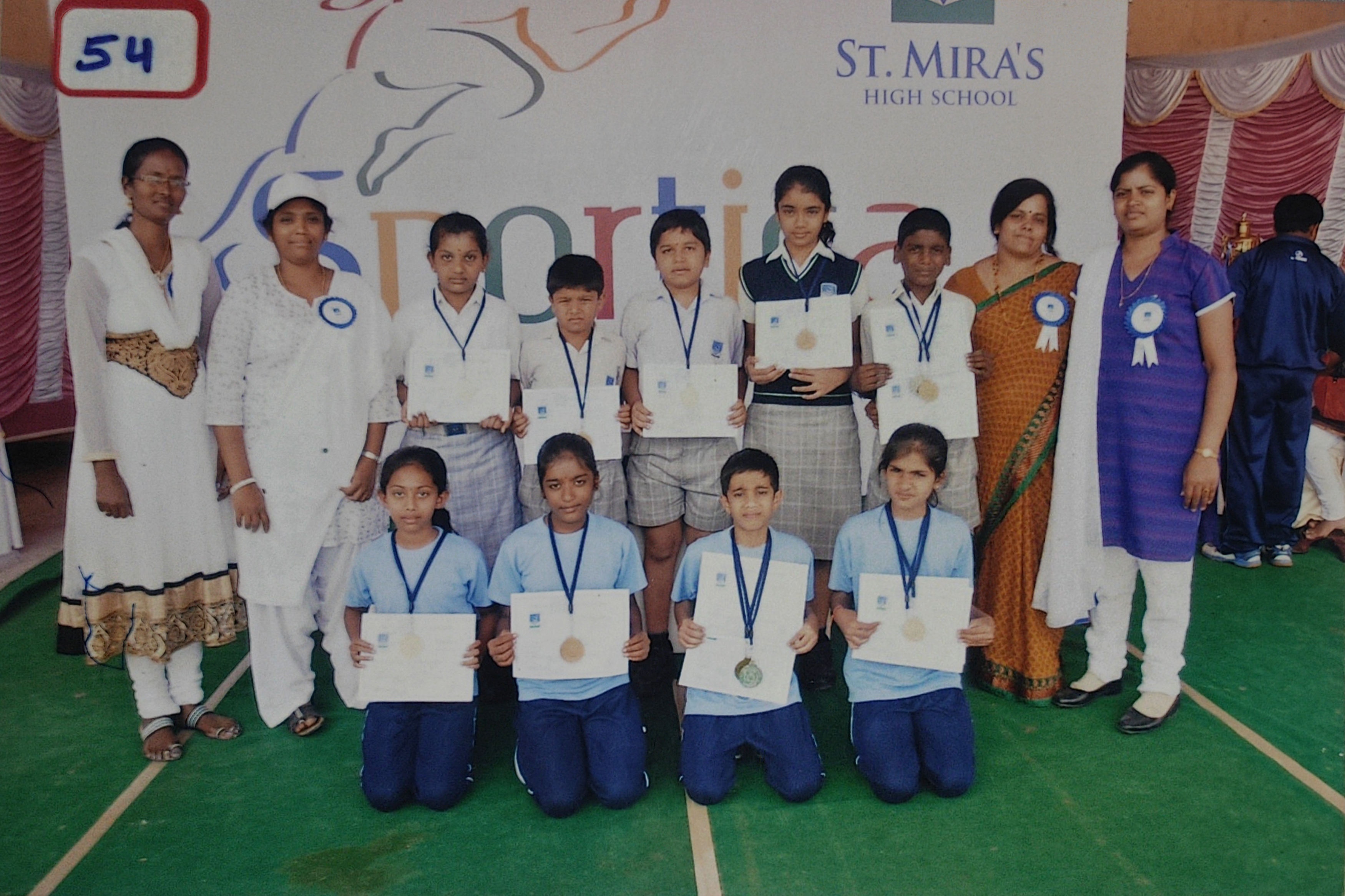 Sportica sports celebration with teammates, certificates, and medals.